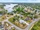 Aerial view of the neighborhood with mature trees, sidewalks, and community lakes and ponds at 780 Kangaroo Ct, Deltona, FL 32738