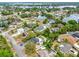 Aerial view of the neighborhood with mature trees, sidewalks, and community lakes and ponds at 780 Kangaroo Ct, Deltona, FL 32738