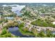 Beautiful aerial view of the community featuring mature trees, a community lake, and natural Florida landscaping at 780 Kangaroo Ct, Deltona, FL 32738