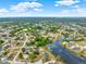 Wide aerial shot highlighting community with ponds and tree cover under a partly cloudy sky at 780 Kangaroo Ct, Deltona, FL 32738