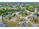 Aerial view showcasing neighborhood with homes, green spaces, and community lakes at 780 Kangaroo Ct, Deltona, FL 32738