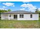 A large backyard with a covered patio that overlooks the well-maintained lawn at 780 Kangaroo Ct, Deltona, FL 32738