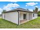 Newly built backyard with covered patio, lush green lawn, and sleek white stucco at 780 Kangaroo Ct, Deltona, FL 32738