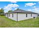 Corner view of backyard featuring manicured lawn, sleek white stucco, and covered patio at 780 Kangaroo Ct, Deltona, FL 32738