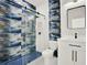 Chic bathroom with a walk-in shower featuring unique tilework, a modern toilet, and a stylish vanity at 780 Kangaroo Ct, Deltona, FL 32738