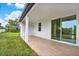 Spacious covered patio with wood-look tile flooring and view of fenced backyard at 780 Kangaroo Ct, Deltona, FL 32738