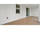 Well-lit covered patio showcasing wood-look tile flooring, leading to a sliding door at 780 Kangaroo Ct, Deltona, FL 32738