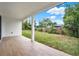 Wide angle shot of the open covered patio and lush backyard at 780 Kangaroo Ct, Deltona, FL 32738