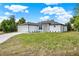 Single-story home featuring a two-car garage, modern stone accents, and a spacious front yard at 780 Kangaroo Ct, Deltona, FL 32738