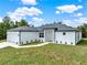 Beautifully landscaped, single-story home featuring a two-car garage and modern gray stone accents at 780 Kangaroo Ct, Deltona, FL 32738