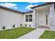 Well-manicured front yard with a walkway leading to a modern-style home featuring stone veneer accents at 780 Kangaroo Ct, Deltona, FL 32738