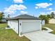 This home features a spacious two-car garage and a well-maintained lawn at 780 Kangaroo Ct, Deltona, FL 32738