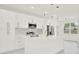 Modern kitchen with white cabinetry, stainless appliances, marble countertops, and a large center island at 780 Kangaroo Ct, Deltona, FL 32738
