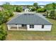 Rear exterior view of the home featuring a new dark roof and a rear covered patio at 780 Kangaroo Ct, Deltona, FL 32738
