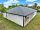Rear exterior view of the home featuring white stucco, new roof, and a rear covered patio at 780 Kangaroo Ct, Deltona, FL 32738