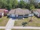A well-kept single-Gathering home featuring a charming yard with a healthy green lawn and a palm tree at 11125 Finchley Pl, Orlando, FL 32837