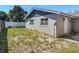 This backyard features green grass, a privacy fence, and a view of the back of the home at 11125 Finchley Pl, Orlando, FL 32837