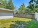 Fenced backyard with green grass and blue sky in residential home at 11125 Finchley Pl, Orlando, FL 32837