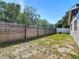 Large backyard with wooden fence. Ready for your personal touch at 11125 Finchley Pl, Orlando, FL 32837