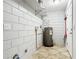 The basement features a utility area with a water heater, tiled floor, and concrete block walls at 11125 Finchley Pl, Orlando, FL 32837