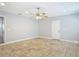 Neutral bedroom with tiled floors, neutral paint, ceiling fan and access to the closet at 11125 Finchley Pl, Orlando, FL 32837