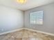 Bright room featuring neutral paint and tiled flooring with a window and blinds at 11125 Finchley Pl, Orlando, FL 32837