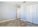 This bedroom features neutral tones, tiled floors, and a spacious closet for ample storage at 11125 Finchley Pl, Orlando, FL 32837