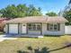 Charming single-Gathering home with a well-maintained lawn, attached garage, and inviting front entrance at 11125 Finchley Pl, Orlando, FL 32837