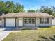 Charming single-Gathering home with a well-maintained lawn, attached garage, and inviting front entrance at 11125 Finchley Pl, Orlando, FL 32837