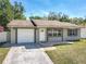Charming single-Gathering home with a well-maintained lawn, attached garage, and inviting front entrance at 11125 Finchley Pl, Orlando, FL 32837