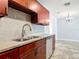 Modern kitchen featuring granite counters, tiled backsplash and stainless steel appliances at 11125 Finchley Pl, Orlando, FL 32837
