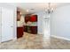 Kitchen and adjacent dining area featuring tile flooring and chandelier at 11125 Finchley Pl, Orlando, FL 32837