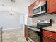 Open kitchen features stainless appliances, granite countertops and a decorative backsplash at 11125 Finchley Pl, Orlando, FL 32837