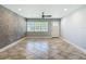 Comfortable living room with large windows, stylish tile floors, and modern ceiling fan at 11125 Finchley Pl, Orlando, FL 32837