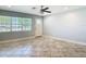 Bright living room showcasing tile floors, large window and white front door at 11125 Finchley Pl, Orlando, FL 32837