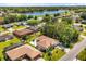 Aerial view of a home and its neighborhood featuring a serene lake and lush trees offering scenic views at 1129 Dartford Dr, Kissimmee, FL 34758