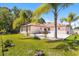 A lush backyard with a pristine lawn and a patio featuring a modern hot tub, perfect for relaxation and outdoor enjoyment at 1129 Dartford Dr, Kissimmee, FL 34758