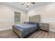 Comfortable bedroom with wood flooring, ceiling fan, and natural light from the window at 1129 Dartford Dr, Kissimmee, FL 34758