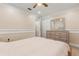 Bright bedroom featuring a ceiling fan, double closet and dresser at 1129 Dartford Dr, Kissimmee, FL 34758