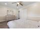 Comfortable bedroom featuring a ceiling fan, laminate floors, and dresser with mirror at 1129 Dartford Dr, Kissimmee, FL 34758