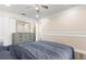 Cozy bedroom with ceiling fan, laminate floors, and dresser featuring a large mirror at 1129 Dartford Dr, Kissimmee, FL 34758
