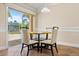 Bright breakfast nook features sliding glass doors to the lanai and a modern light fixture at 1129 Dartford Dr, Kissimmee, FL 34758