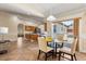 Cozy dining area featuring a modern table, chairs, and sliding glass doors to the backyard at 1129 Dartford Dr, Kissimmee, FL 34758