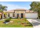 Charming single-story home with a well-manicured lawn and inviting curb appeal on sunny day at 1129 Dartford Dr, Kissimmee, FL 34758