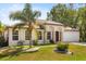 Charming single-story home with a well-manicured lawn and lush landscaping at 1129 Dartford Dr, Kissimmee, FL 34758