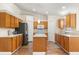 Well-lit kitchen with stainless refrigerator, center island and ample cabinet and countertop space at 1129 Dartford Dr, Kissimmee, FL 34758