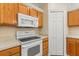 Bright kitchen with microwave over range, ample counter space, and double-door pantry at 1129 Dartford Dr, Kissimmee, FL 34758