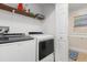 Convenient laundry room with washer, dryer, utility sink, shelving, and natural light at 1129 Dartford Dr, Kissimmee, FL 34758