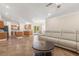 Open-concept living room features a modern ceiling fan and seamless access to the kitchen at 1129 Dartford Dr, Kissimmee, FL 34758