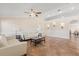 Bright, open-concept living room with neutral tones, tile floors, and vaulted ceilings at 1129 Dartford Dr, Kissimmee, FL 34758